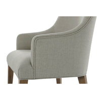 Classic upholstered armchair, armrest close-up, soft fabric.