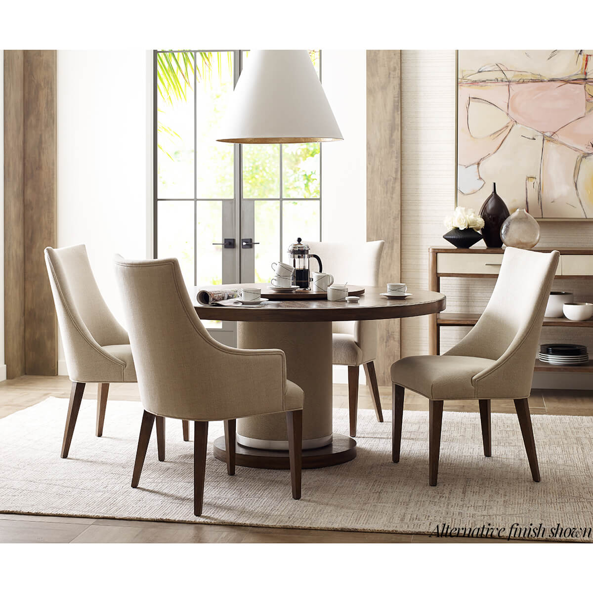 Dining setup with classic upholstered armchairs around table.