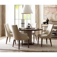 Dining setup with classic upholstered armchairs around table.