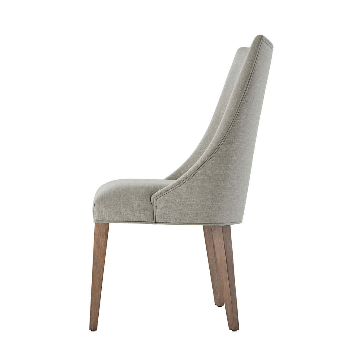 Side profile of upholstered dining chair with scoop back.