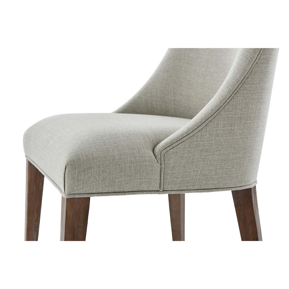 Detailed view of chair seat and wooden legs.