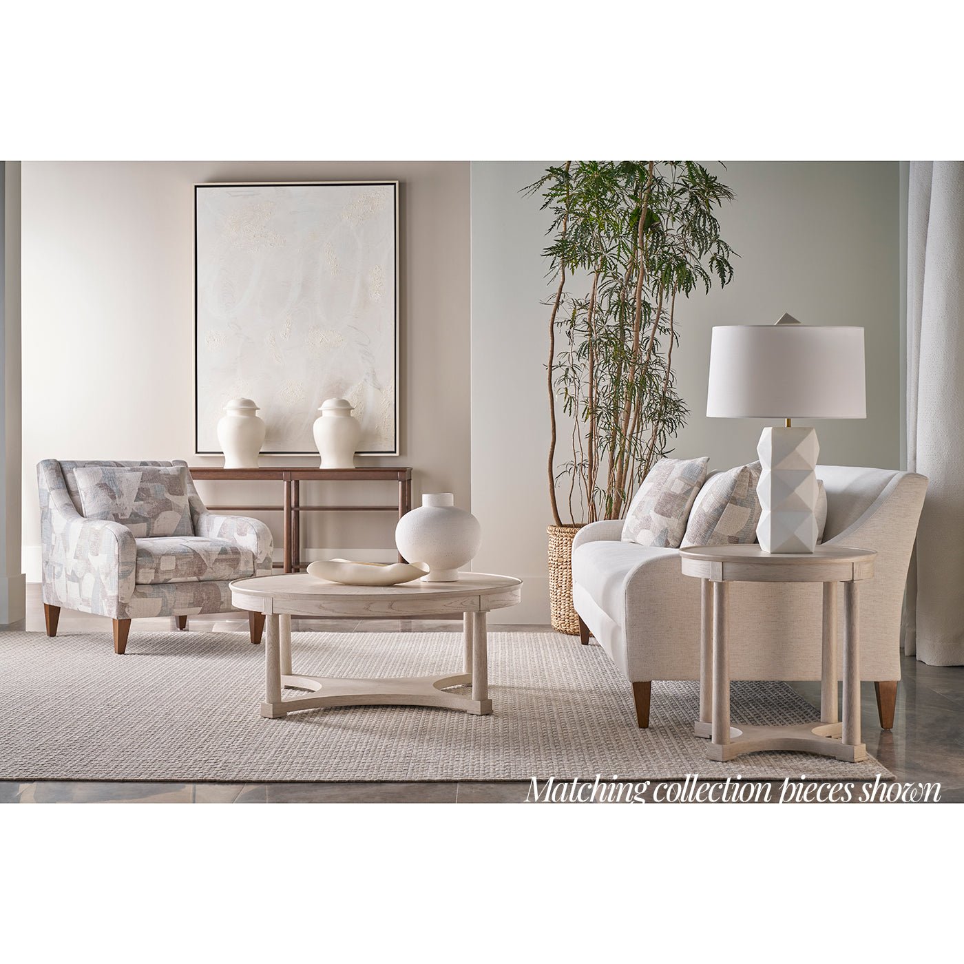 Round coffee table in elegant, coordinated living room.