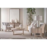 Round coffee table in elegant, coordinated living room.