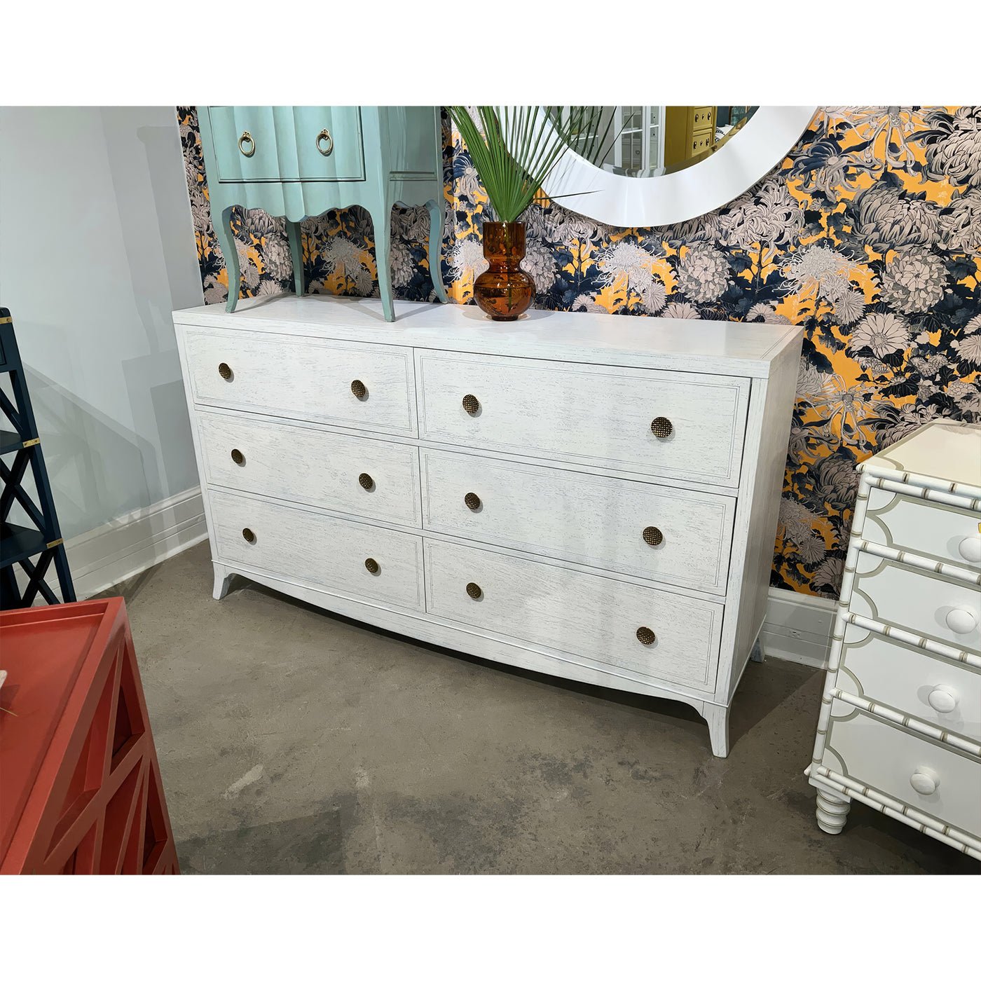 White double dresser on display in showroom setting.