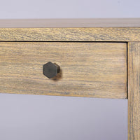 Close-up of wide side table drawer knob, hexagonal shape.