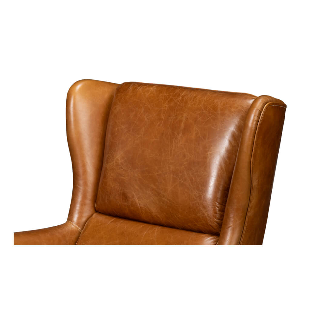 Upper backrest of brown leather wingback chair.
