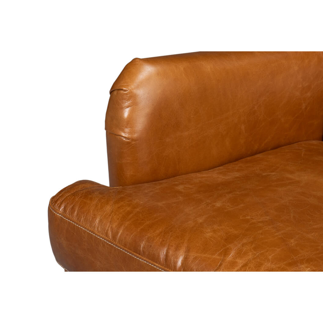 Arm and seat cushion detail on leather wingback chair.