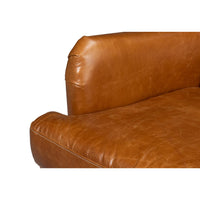 Arm and seat cushion detail on leather wingback chair.