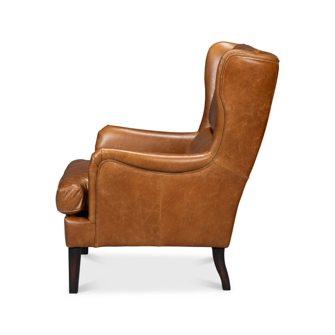 Side profile of brown leather wingback chair.