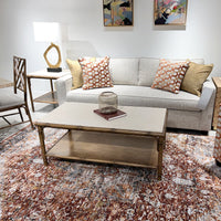 Bamboo coffee table in living room with colorful rug.