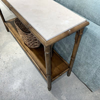 Close-up of bamboo console table, marble texture top.
