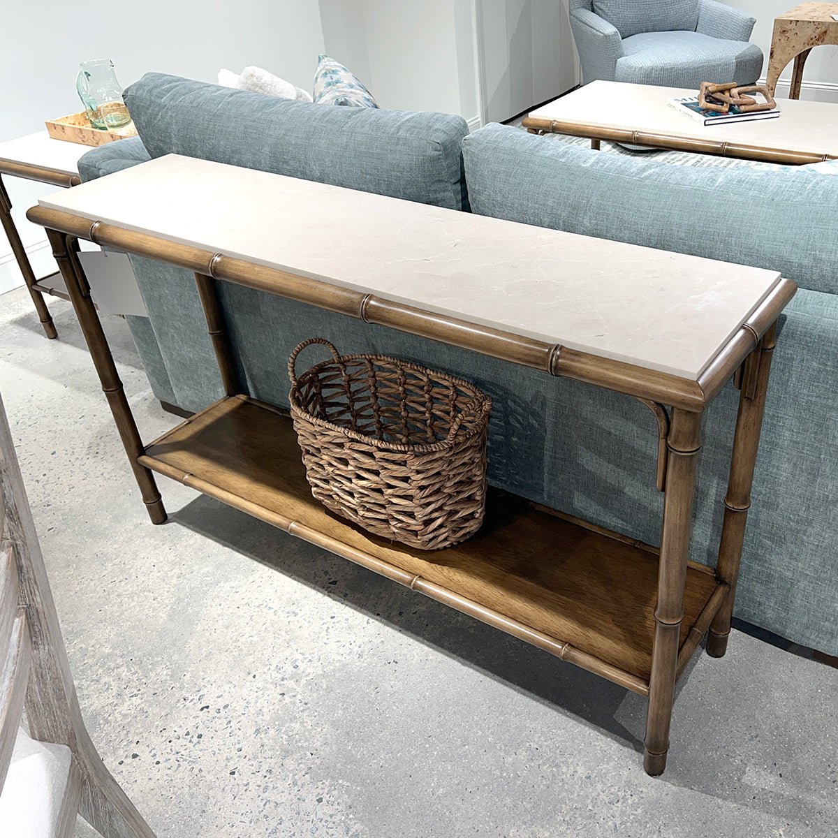 Bamboo console table with basket, living room setup.
