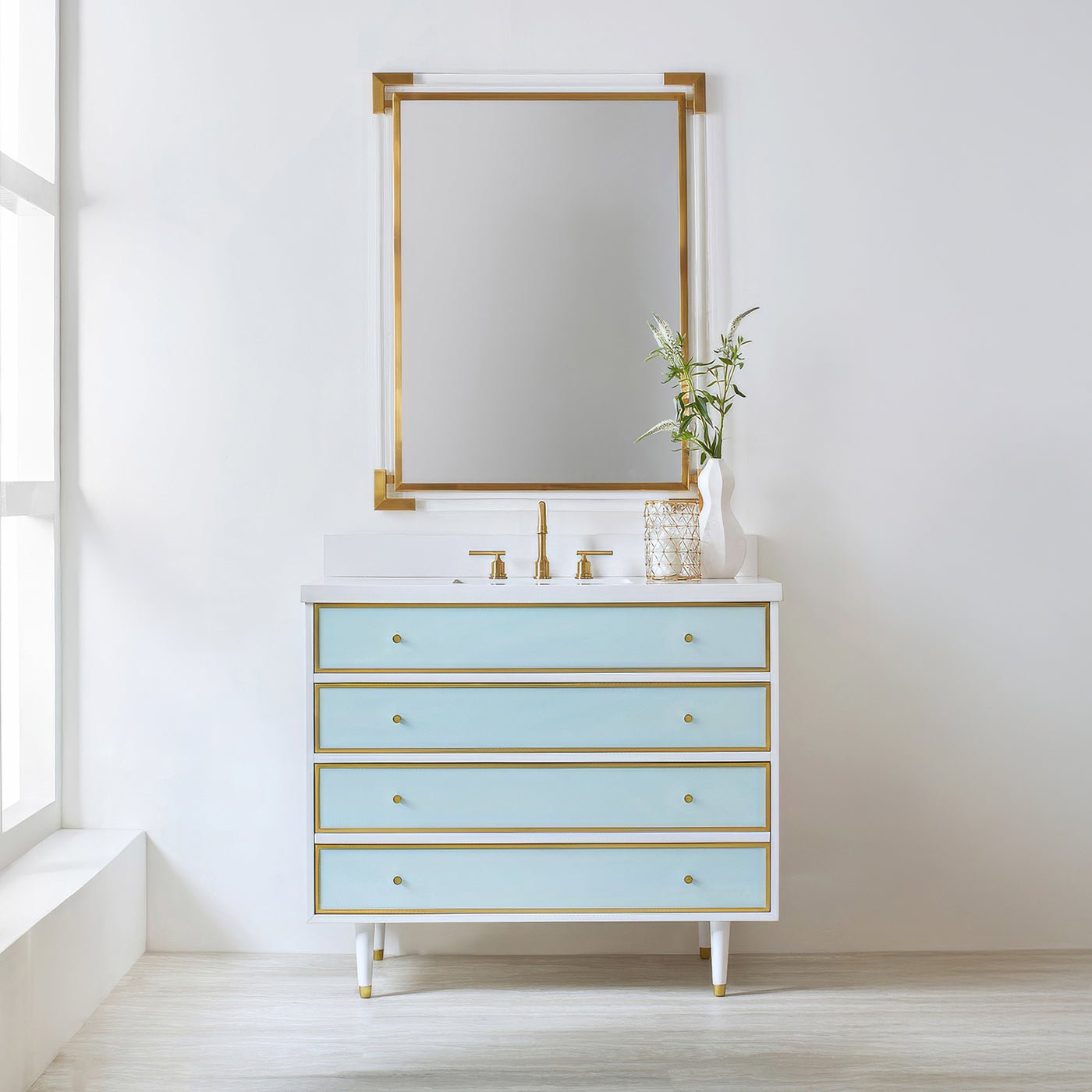 Vanity with mirror, coastal theme, blue drawers, gold accents.