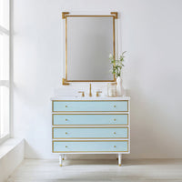 Vanity with mirror, coastal theme, blue drawers, gold accents.