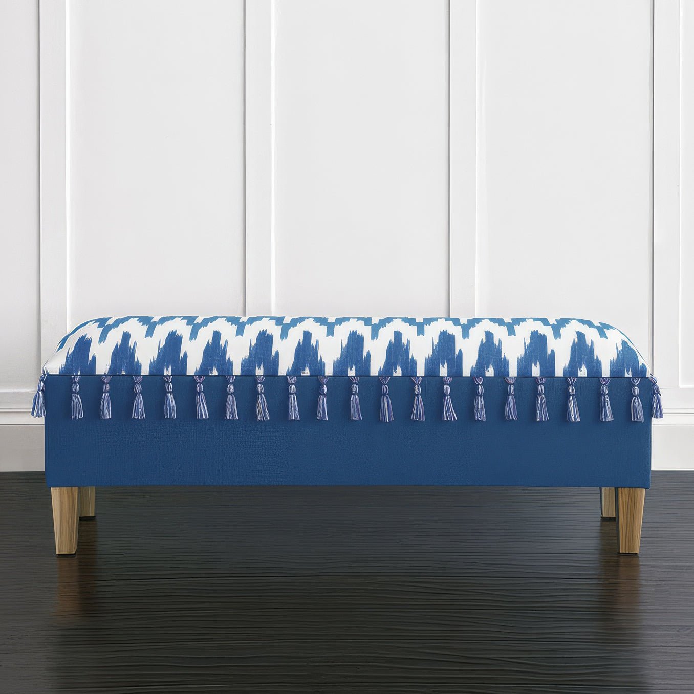 Front view of coastal blue bench with tassel accents.