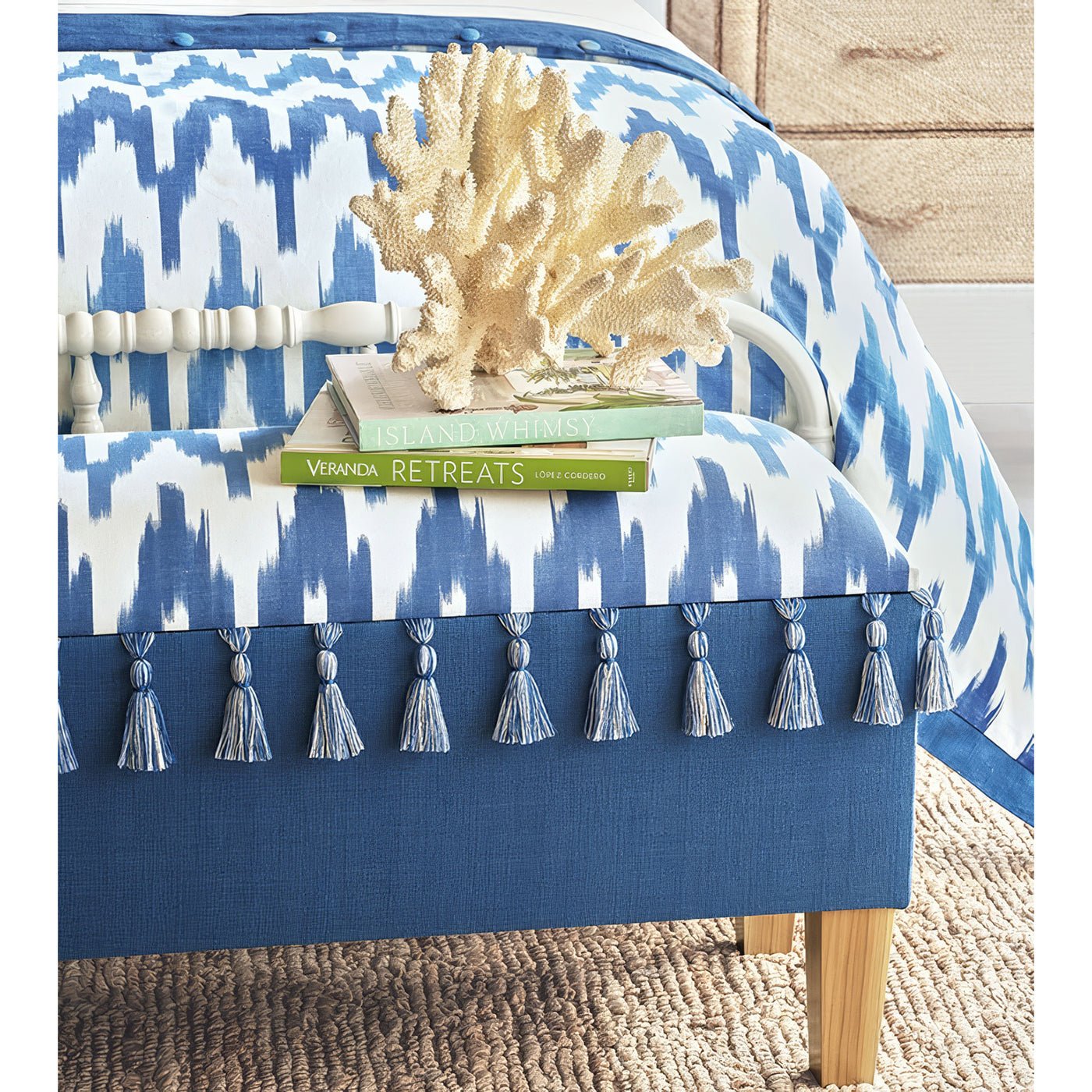 Styled coastal blue bench with decor items and books.