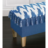 Close-up of tassel and fabric pattern on blue bench.