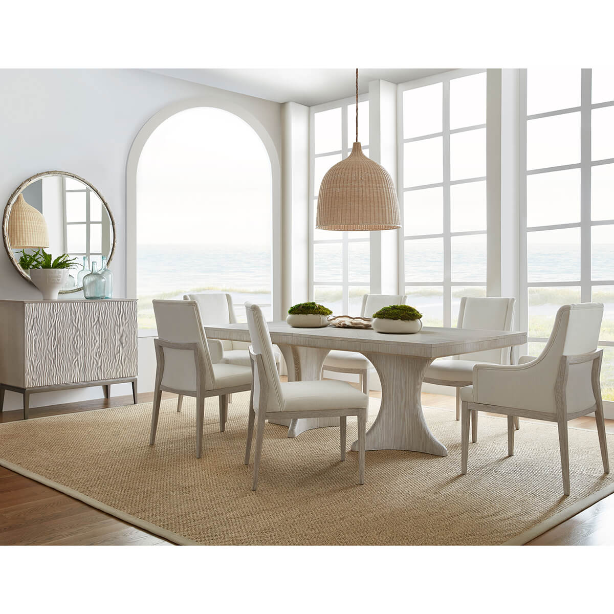 Dining room with white table, chairs, and decor.
