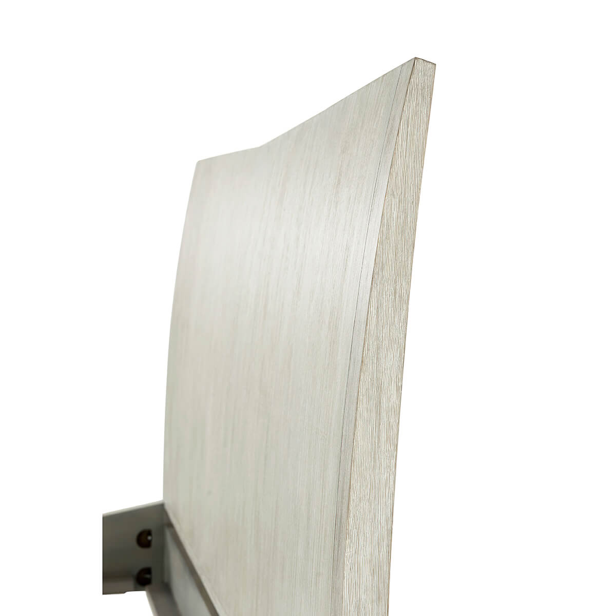 Close-up of bed's angled headboard detail.