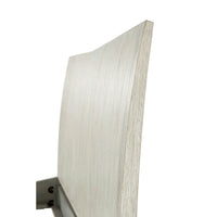 Close-up of bed's angled headboard detail.