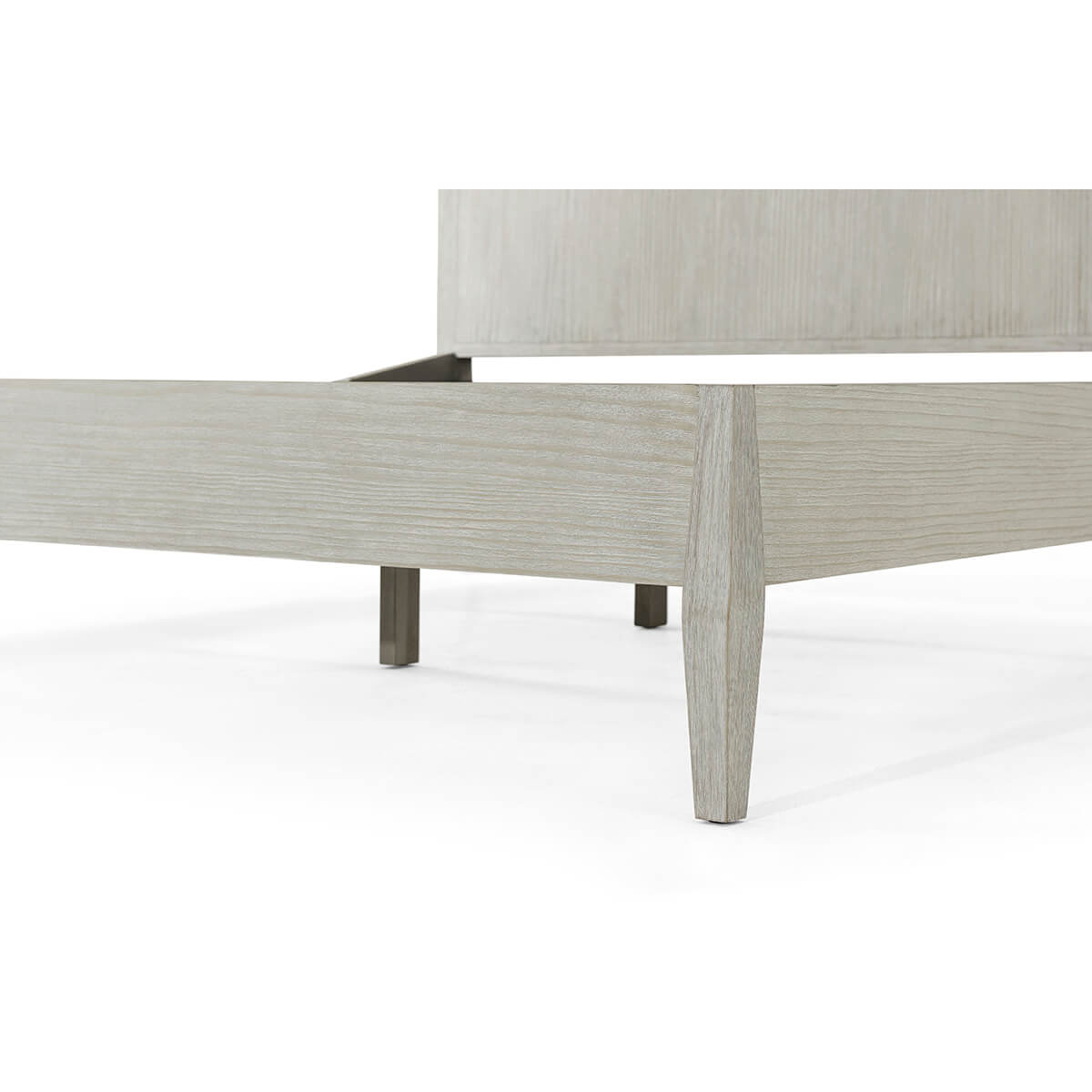 Close-up of bed's footboard and legs.