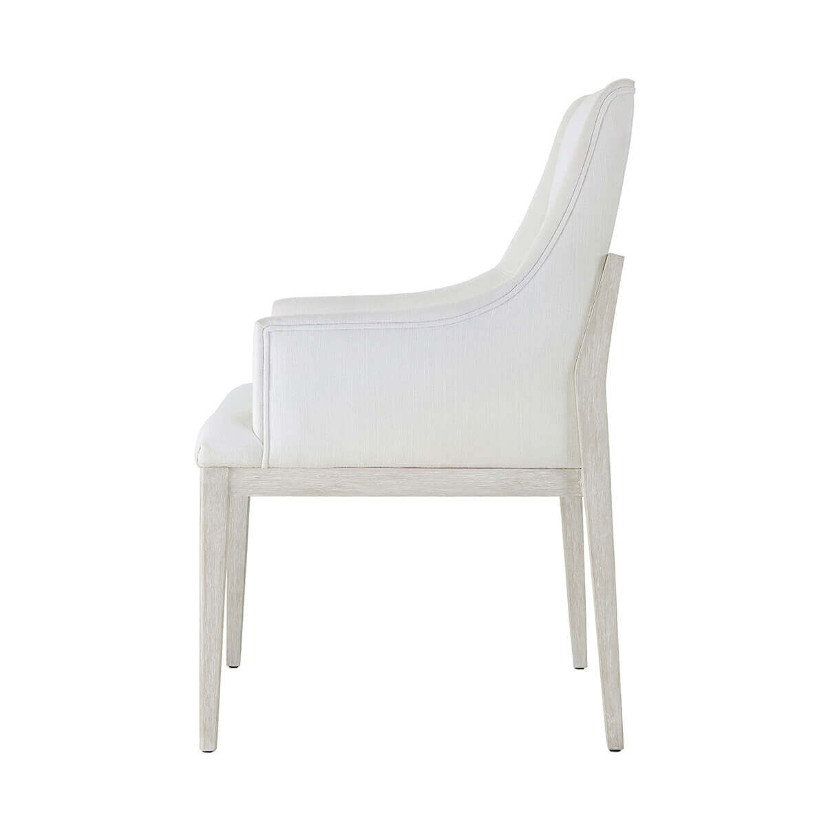Side profile of white upholstered dining chair.