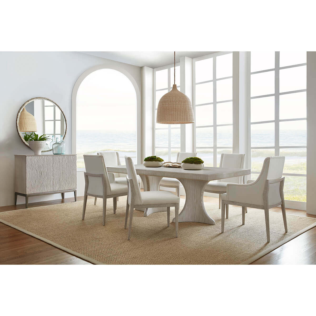 Dining room setting with coastal-style upholstered chairs.