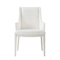 Front view of white upholstered dining chair.