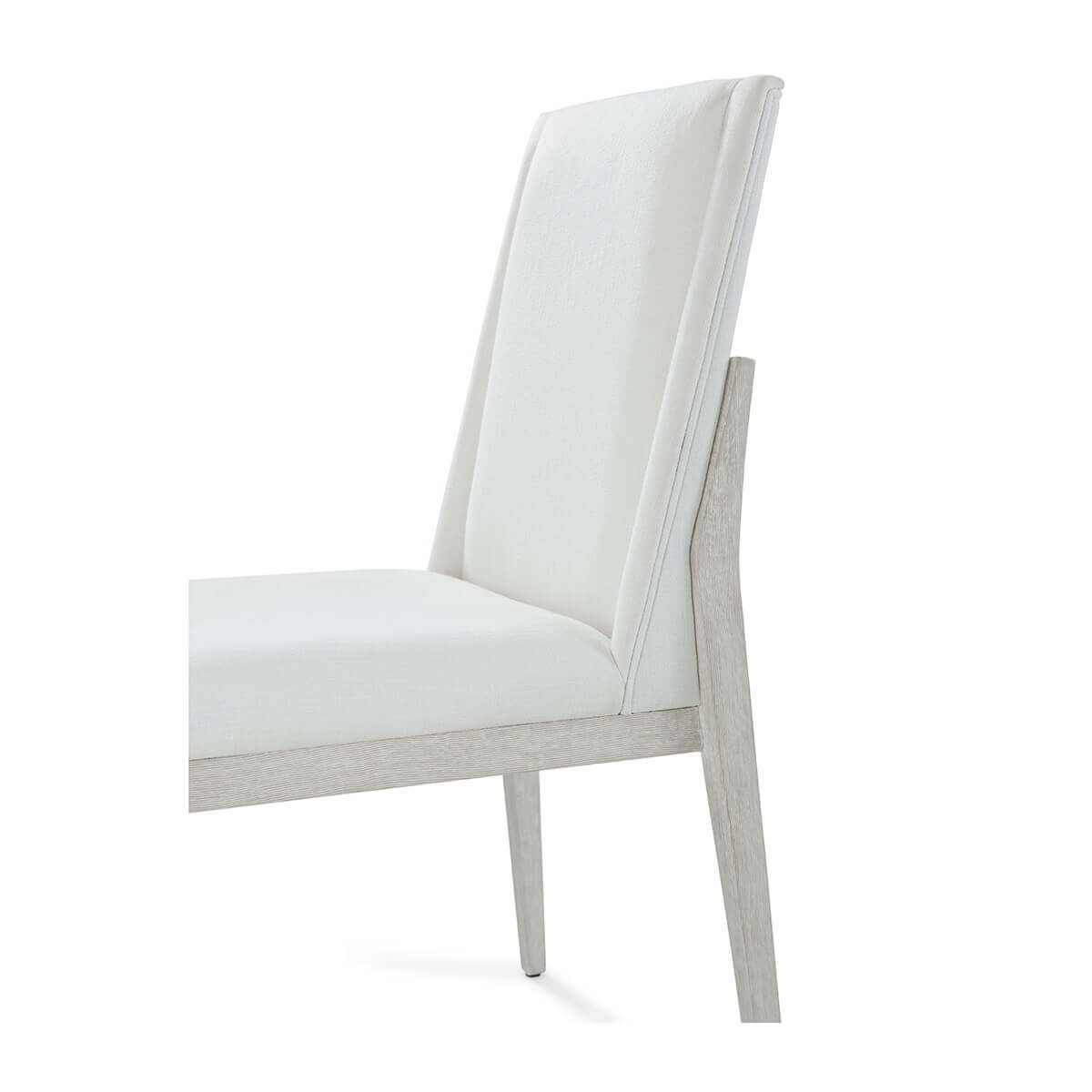 White upholstered dining chair, backrest angle close-up.