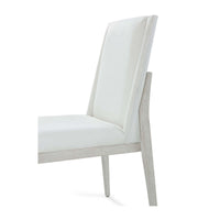 White upholstered dining chair, backrest angle close-up.