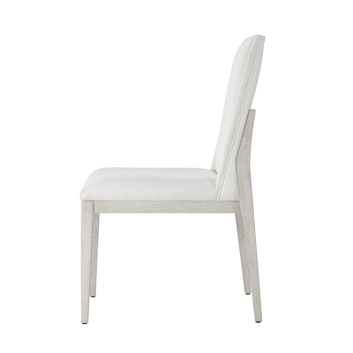 White upholstered dining chair, side profile view.