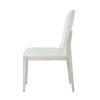White upholstered dining chair, side profile view.