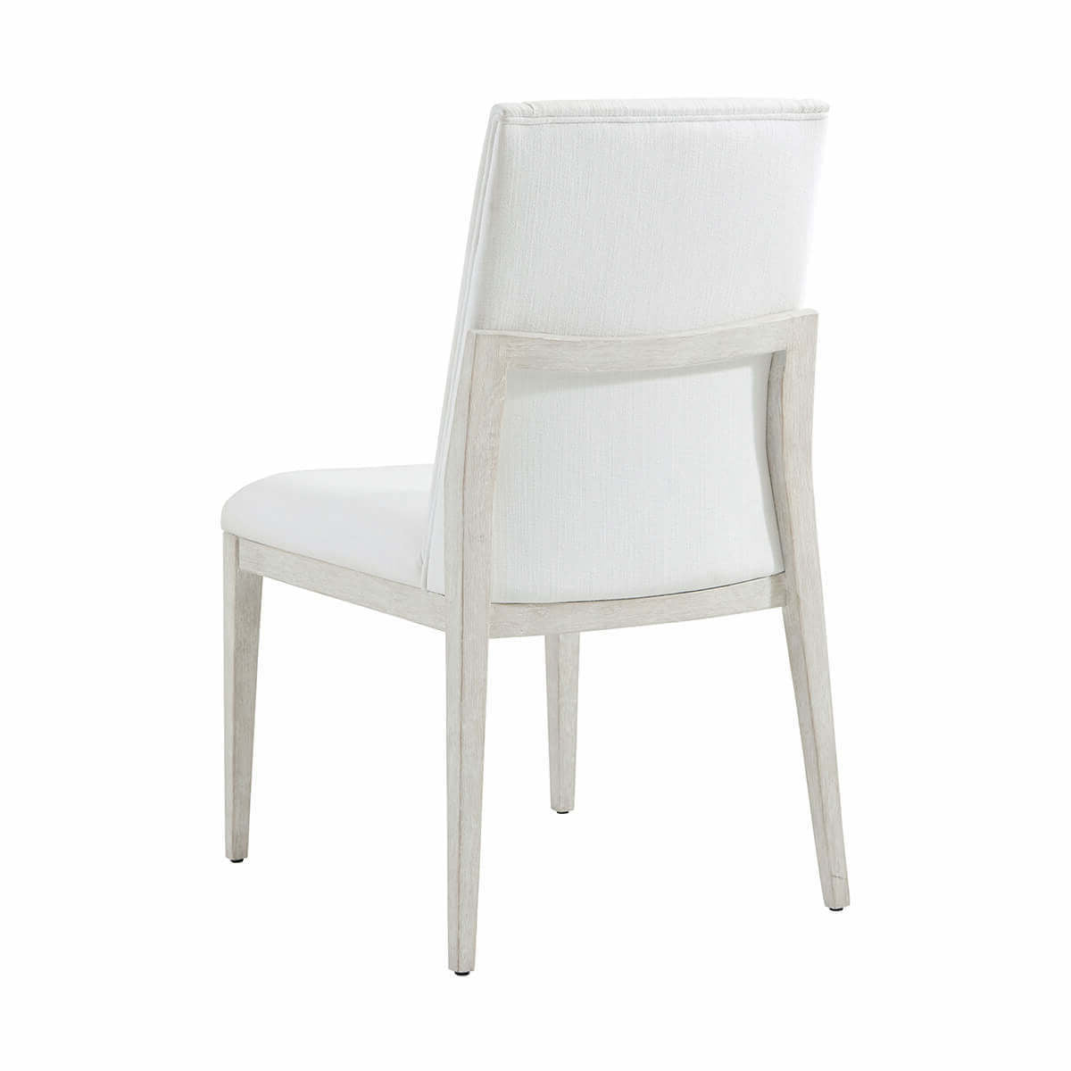 White upholstered dining chair, back angle view.