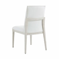 White upholstered dining chair, back angle view.