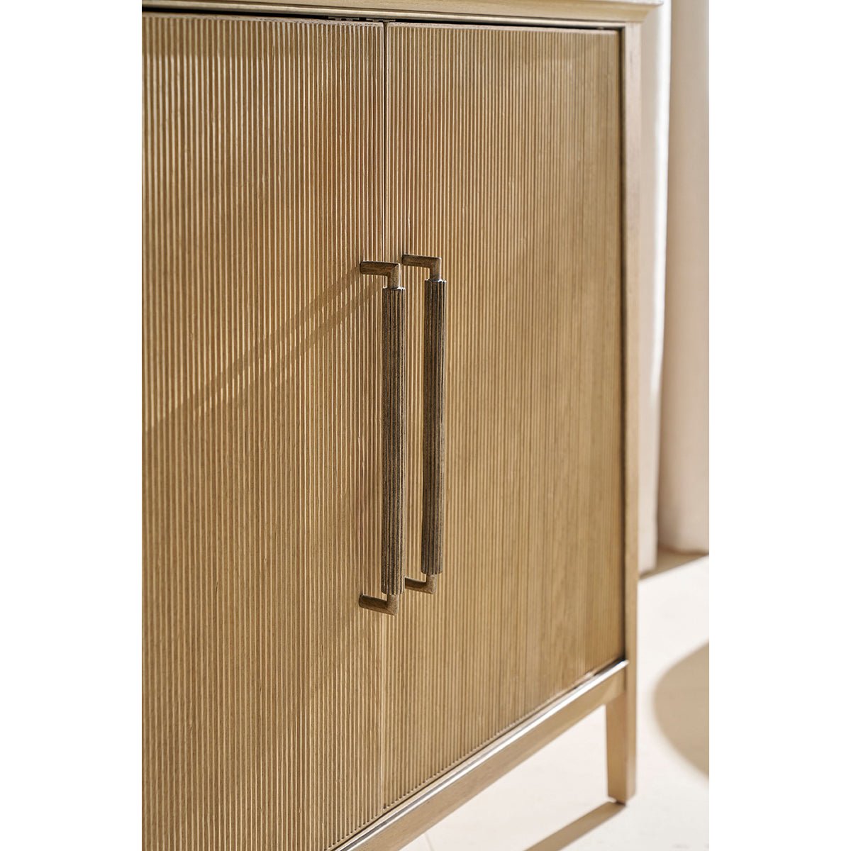 Close-up of oak sideboard's textured doors and handle.