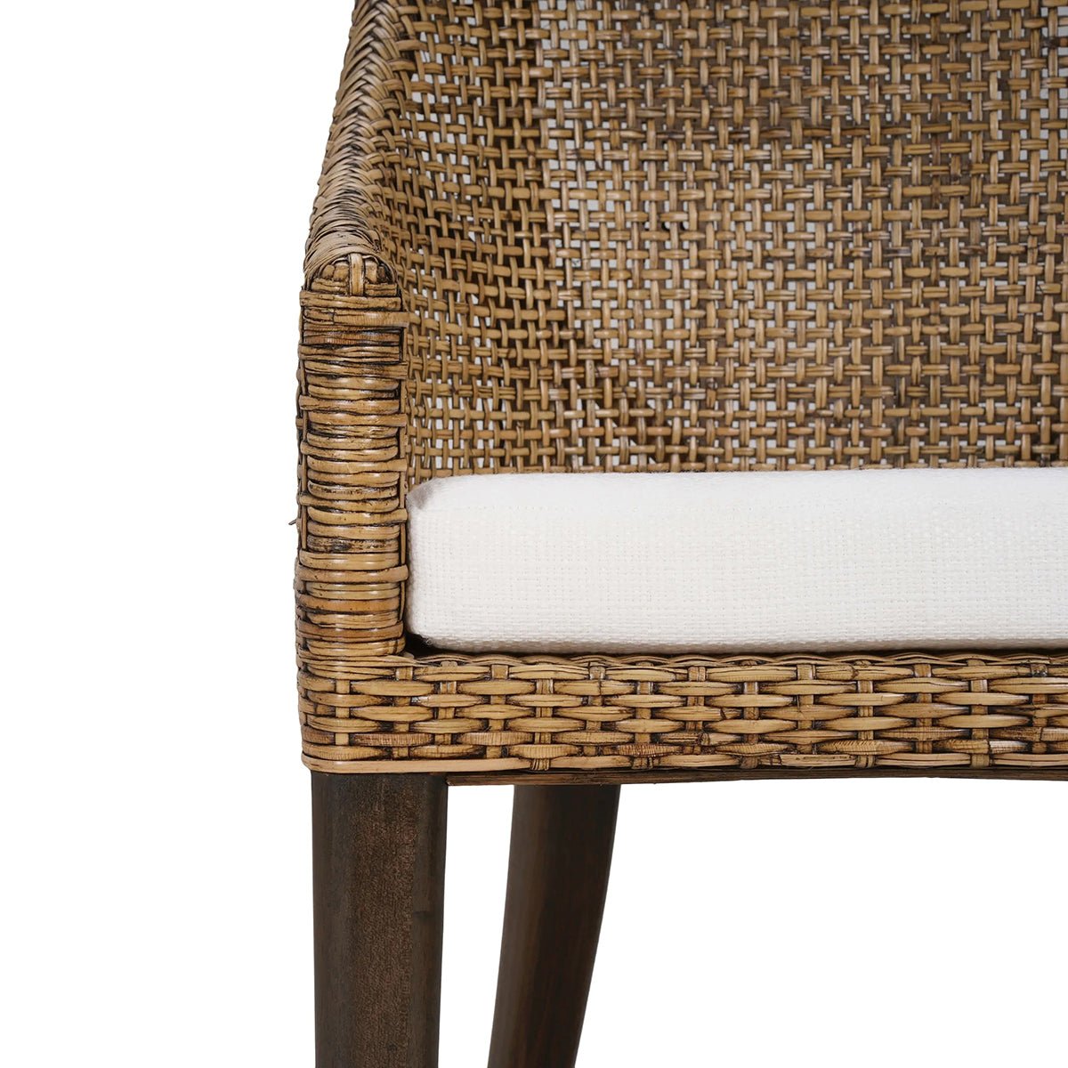 Detail of cushion and woven rattan on dining chair.