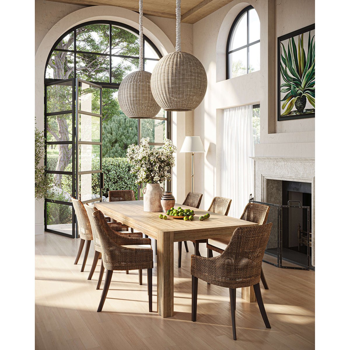 Dining room featuring coastal rattan dining chairs and large windows.
