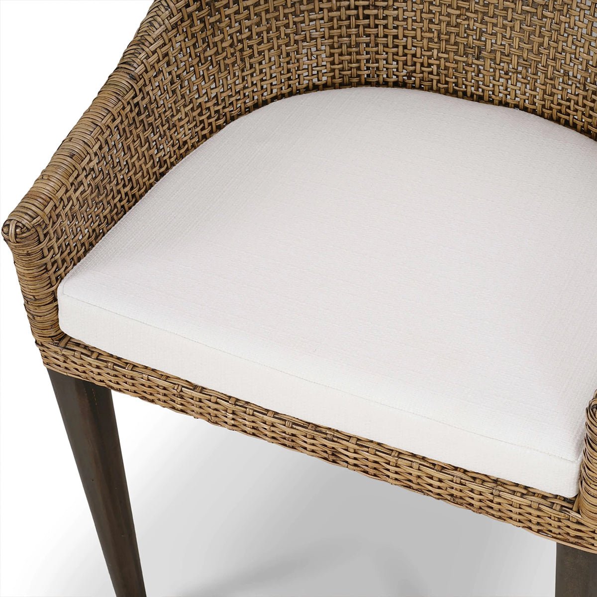 Top view of white cushion on rattan dining chair.