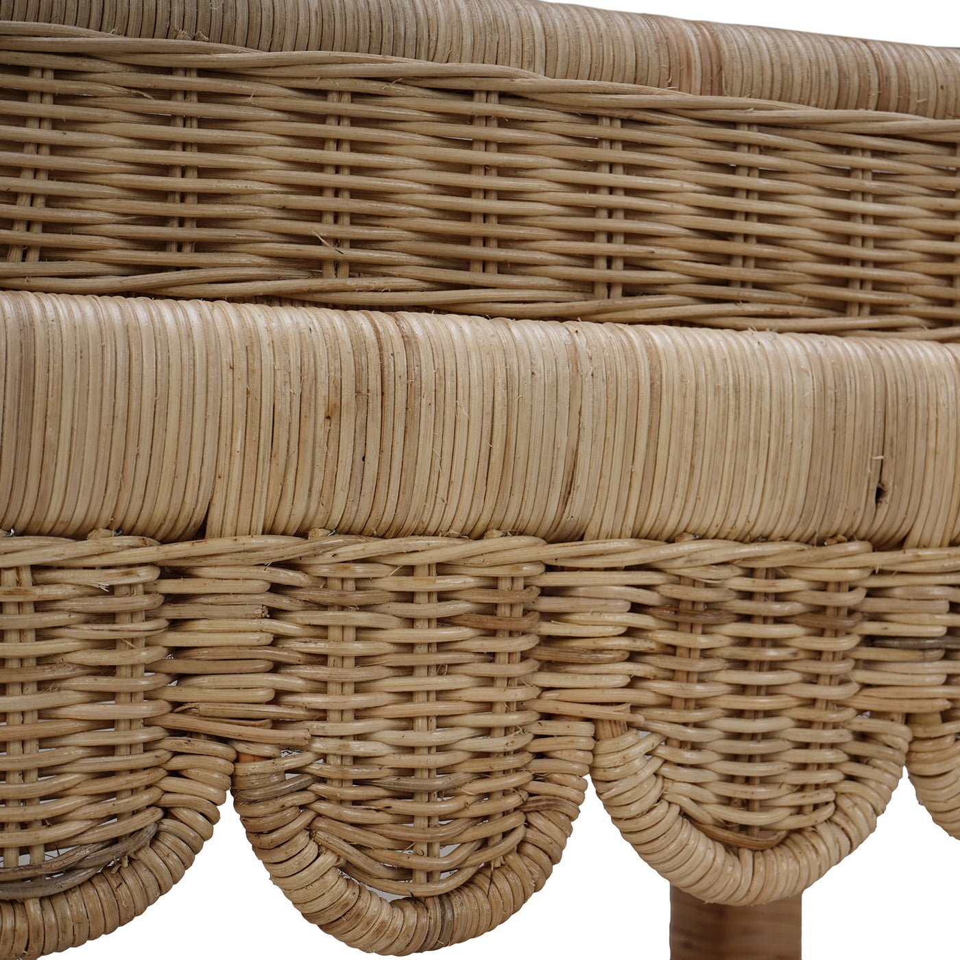 Detailed view of rattan table weaving and scallops.