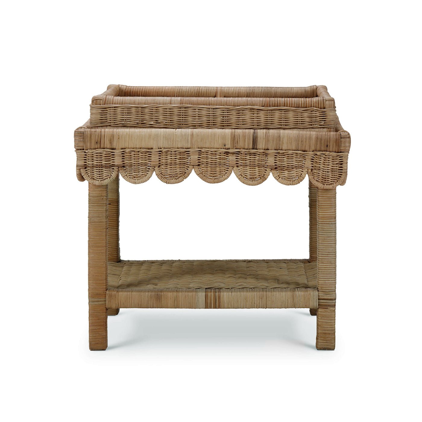Rattan table with scalloped edge, back view.