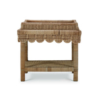 Rattan table with scalloped edge, back view.