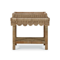Rattan table with scalloped edge, front view.
