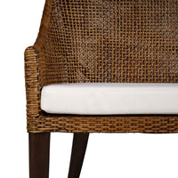 Detailed view of coastal rattan settee arm and seat.