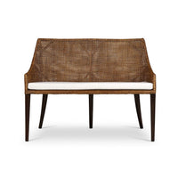 Front view of coastal rattan settee with cushion.