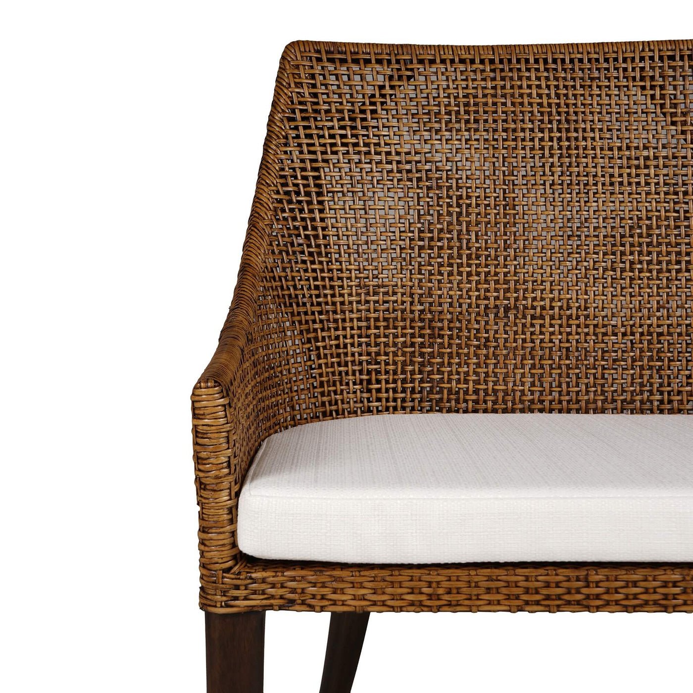 Close-up of coastal rattan settee arm and cushion.