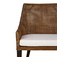 Close-up of coastal rattan settee arm and cushion.