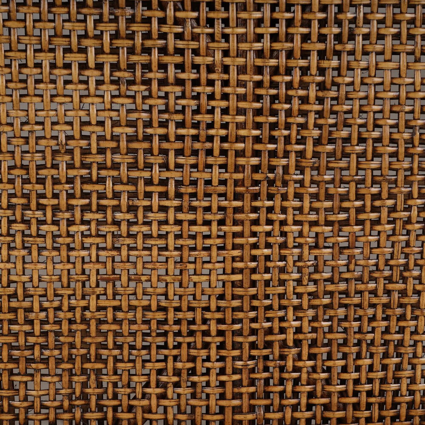 Detailed shot of woven rattan texture on settee.