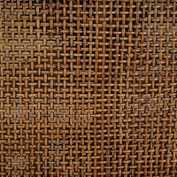 Detailed shot of woven rattan texture on settee.