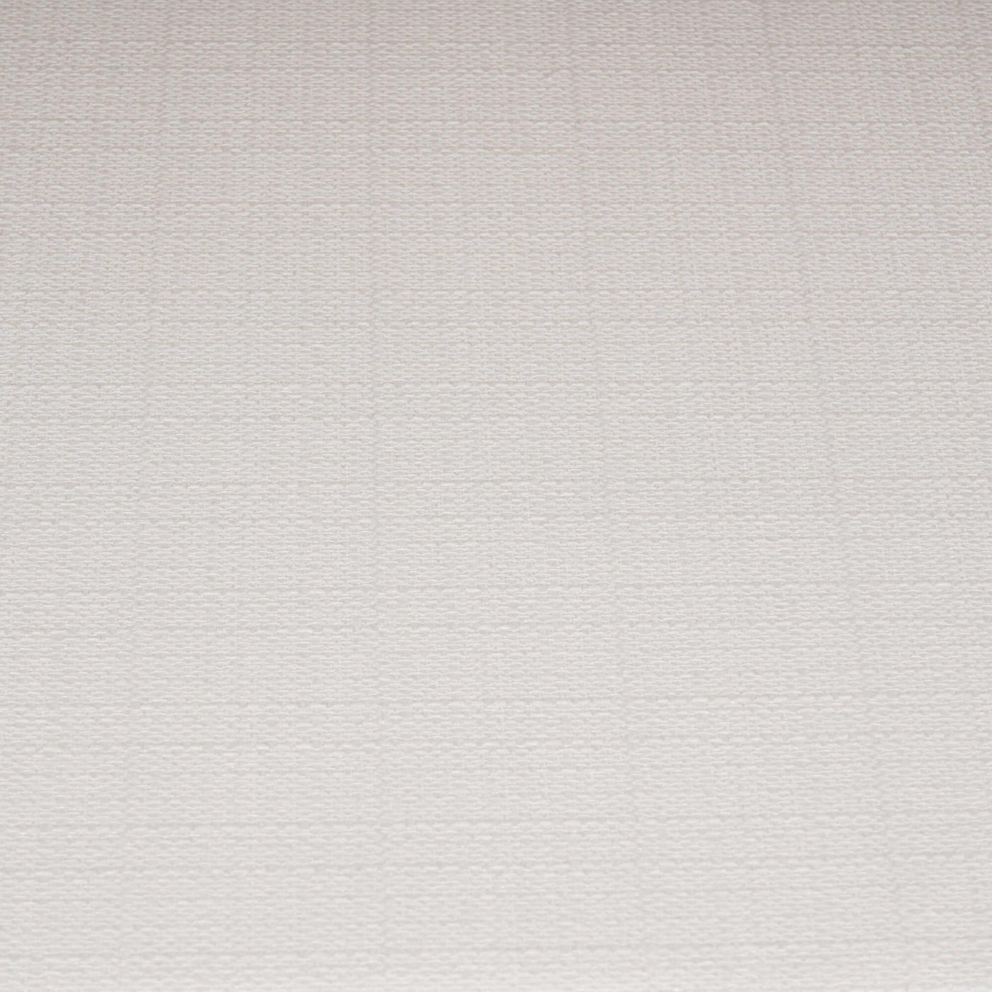 Close-up of white cushion on coastal rattan settee.
