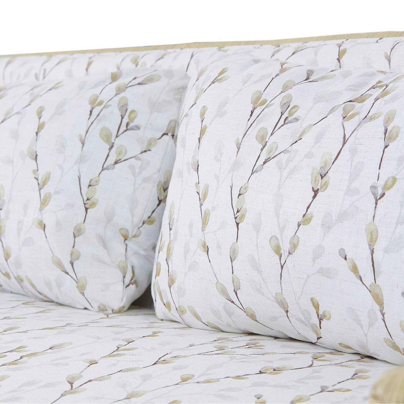 Botanical cushions and seat detail on rattan settee.
